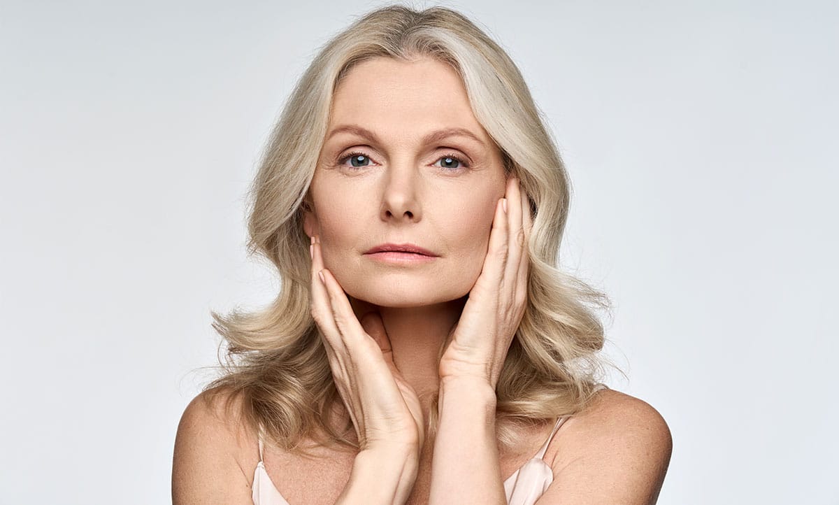 woman holding her face after getting Botox from New York Group for Plastic Surgery.