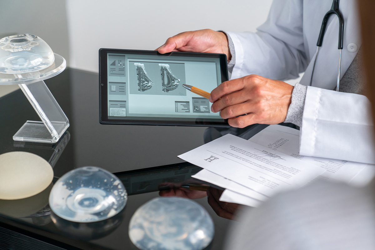 doctor discussing breast augmentation options with a client in New York City