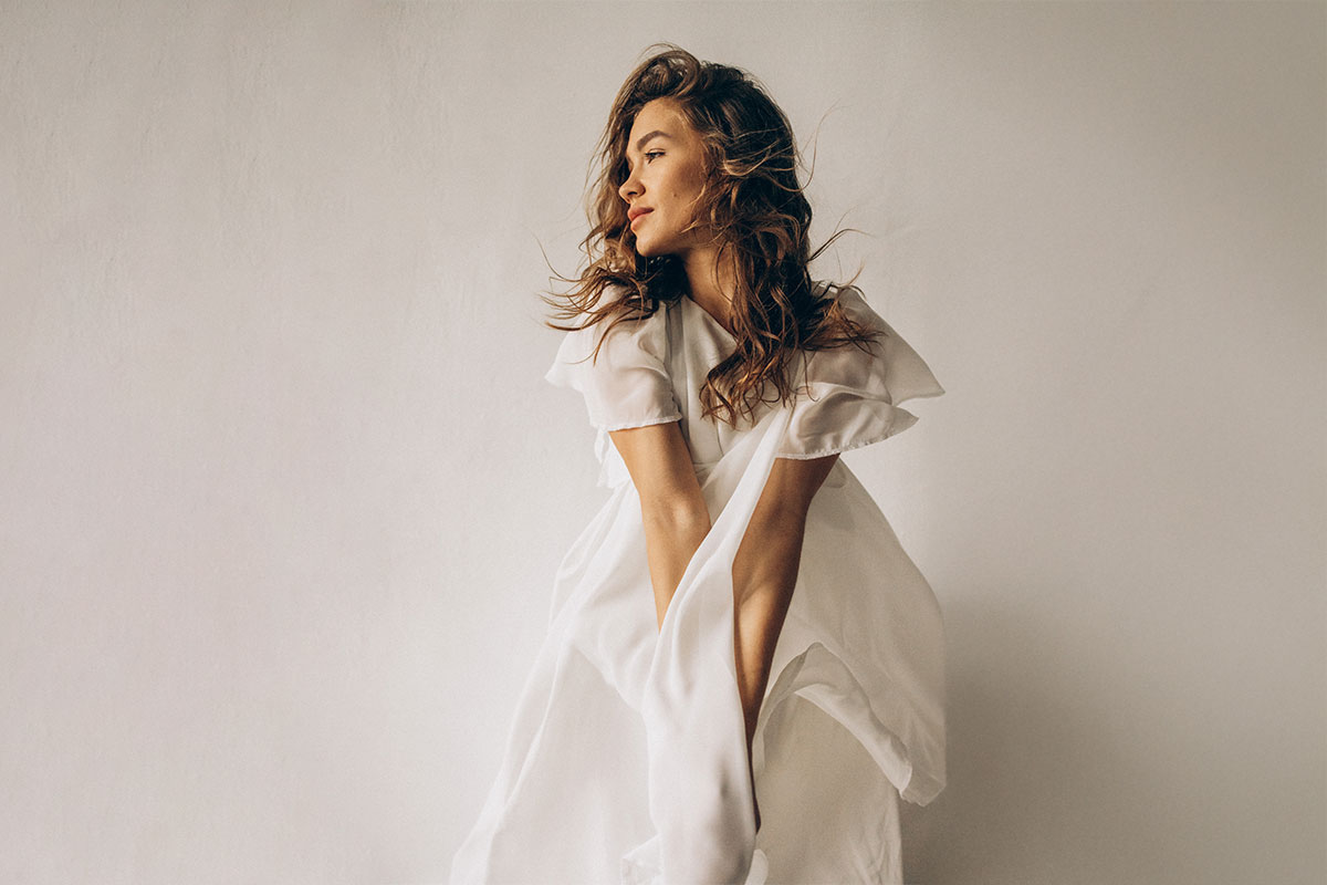 woman happily gazing off after getting the best mommy makeover in NYC